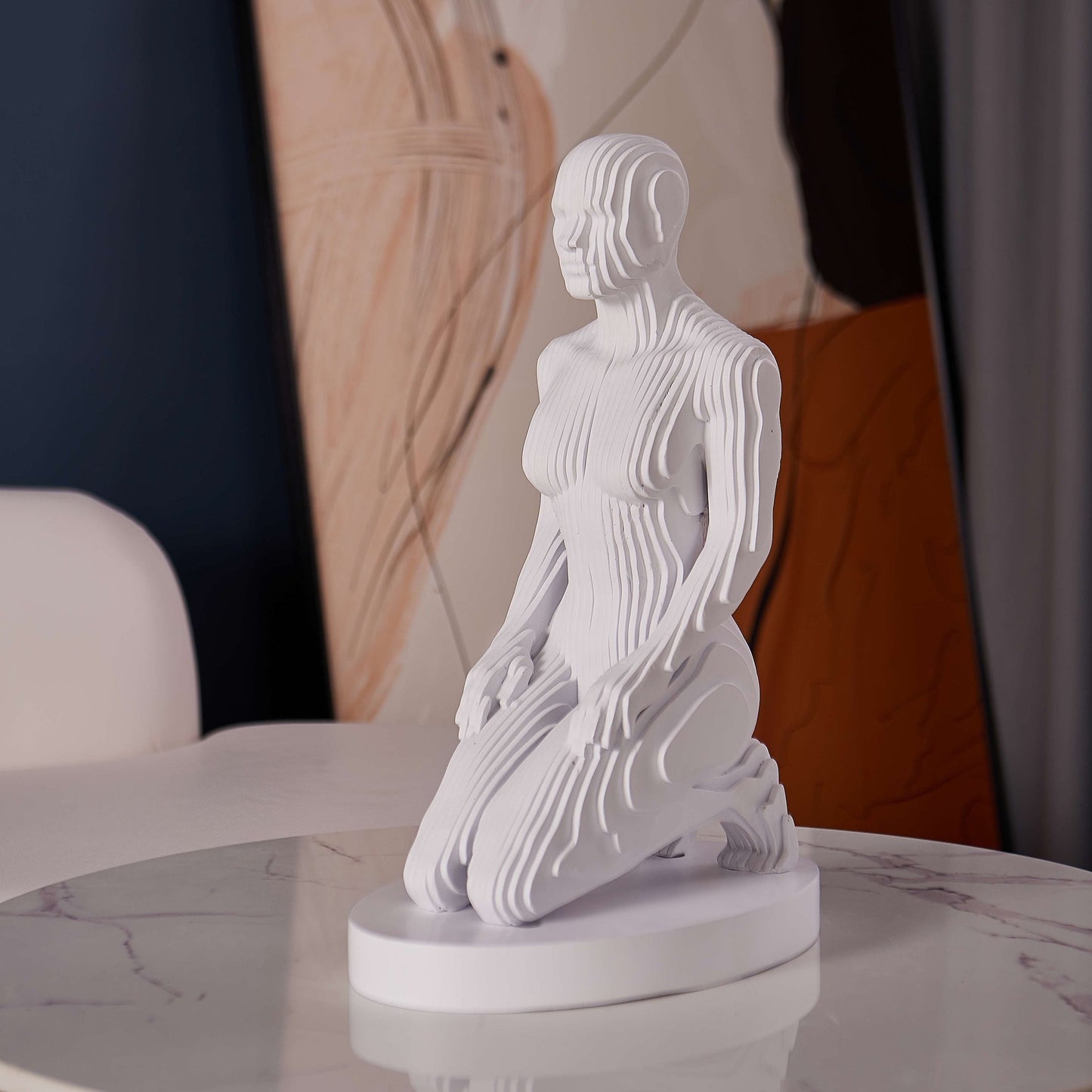 Matte white kneeling woman sculpture with pixelated form